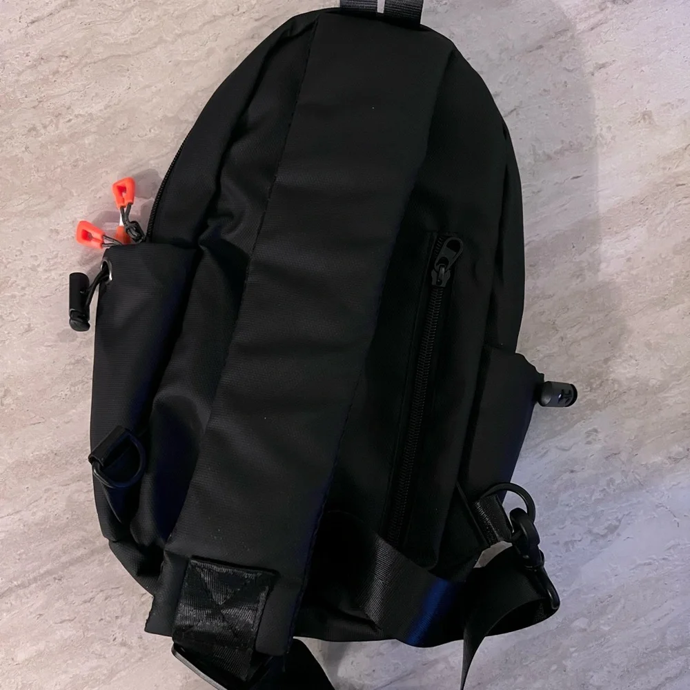 Waterproof Travel Sling Bag- Unisex. Black with Orange accents.